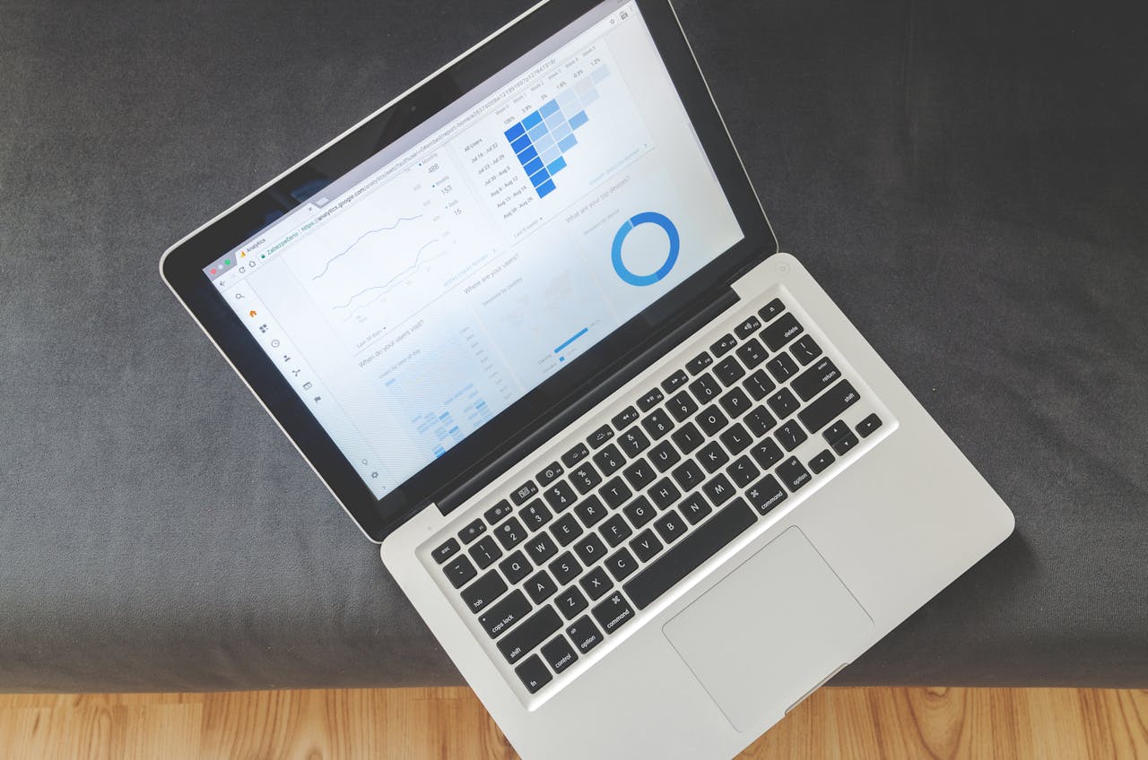 about-01 Overhead view of a laptop showing data visualizations and charts on its screen.